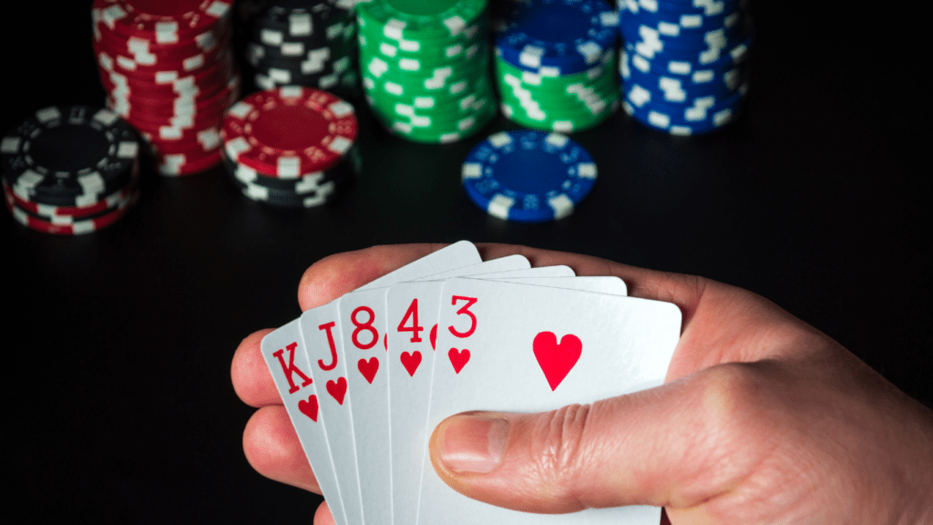 Holding playing cards and casino token